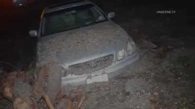Mudslides trap drivers, bury roads and damage homes in Southern California